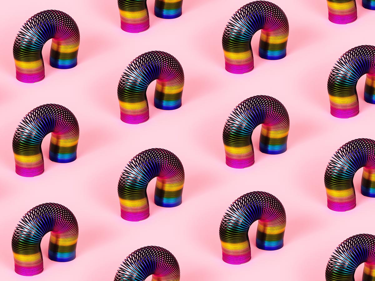 colorful retro toys, slinky pattern over pink background