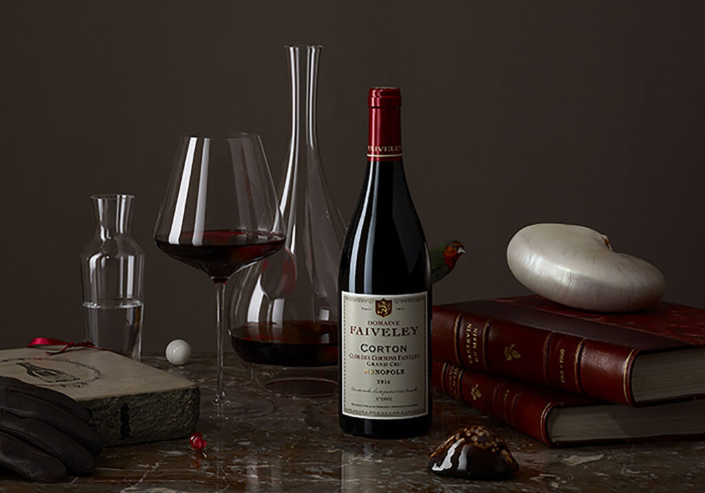 Photo of the wine bottle and wine glasses filled with Domaine Faiveley, Clos Des Cortons Grand Cru Monopole