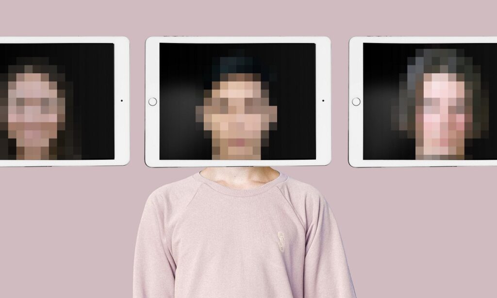 A person stands in front of a pink wall. An iPad is being held in front of their face and the image of their face is distorted, so you can't be sure who you're seeing.