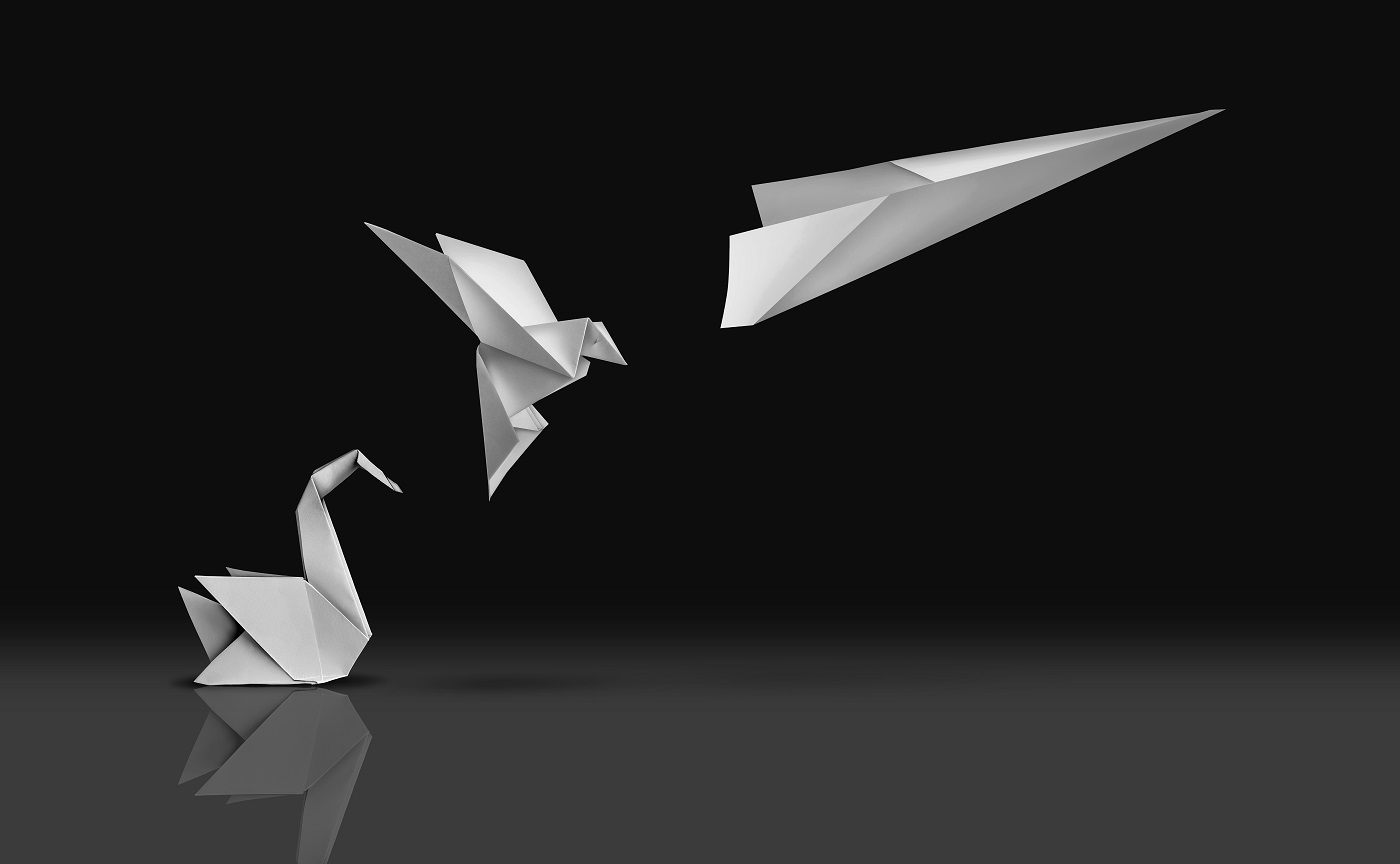Picture of an origami swan transforming into a paper airplane evoking the concept of innovation and transformation