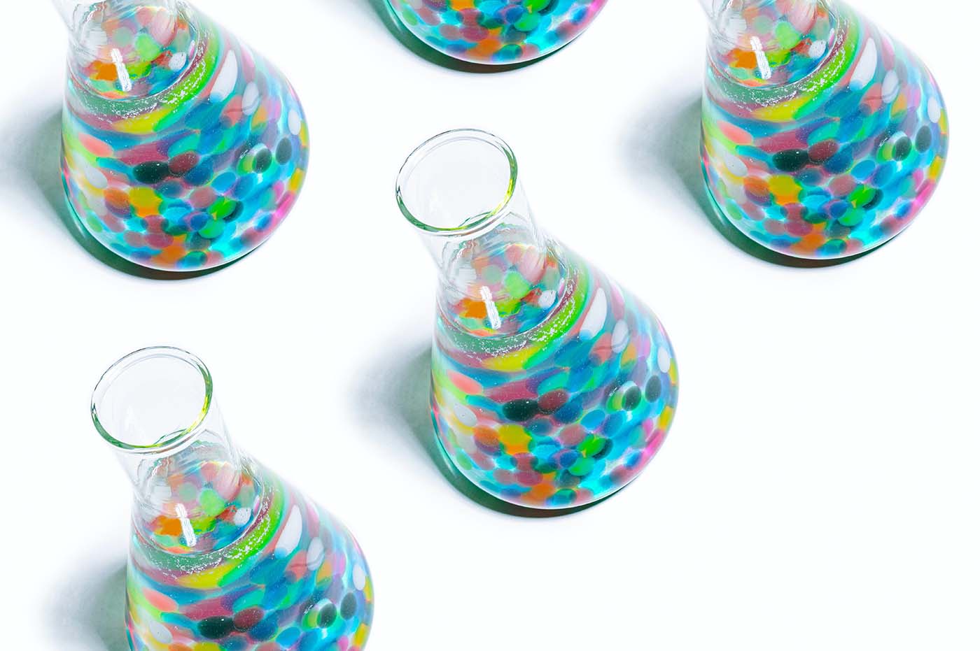 Photo of Erlenmeyer flasks filled with colorful items