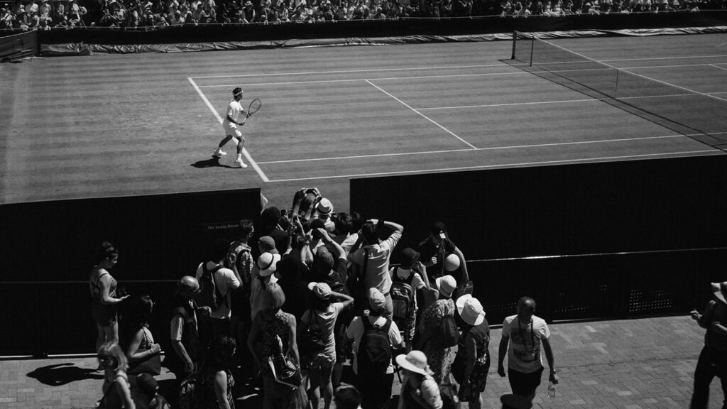 Grayscale photo of person playing tennis, © Howard Bouchevereau / Unsplash