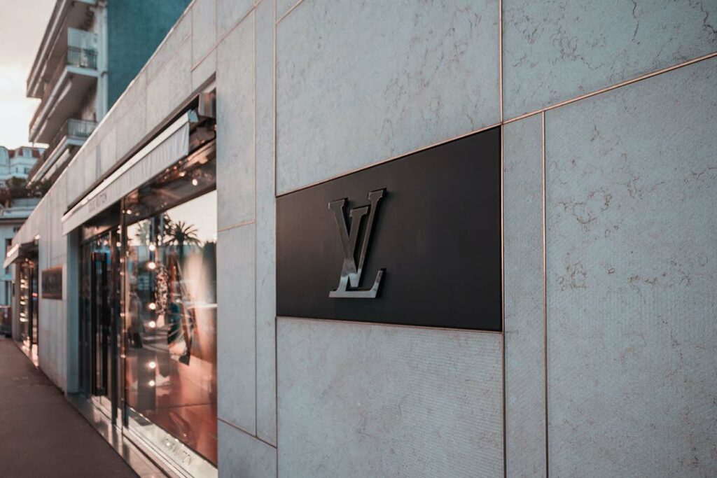 Feature photo by Jannis Lucas/Unsplash. Photo of Louis Vuitton logo outside a store.