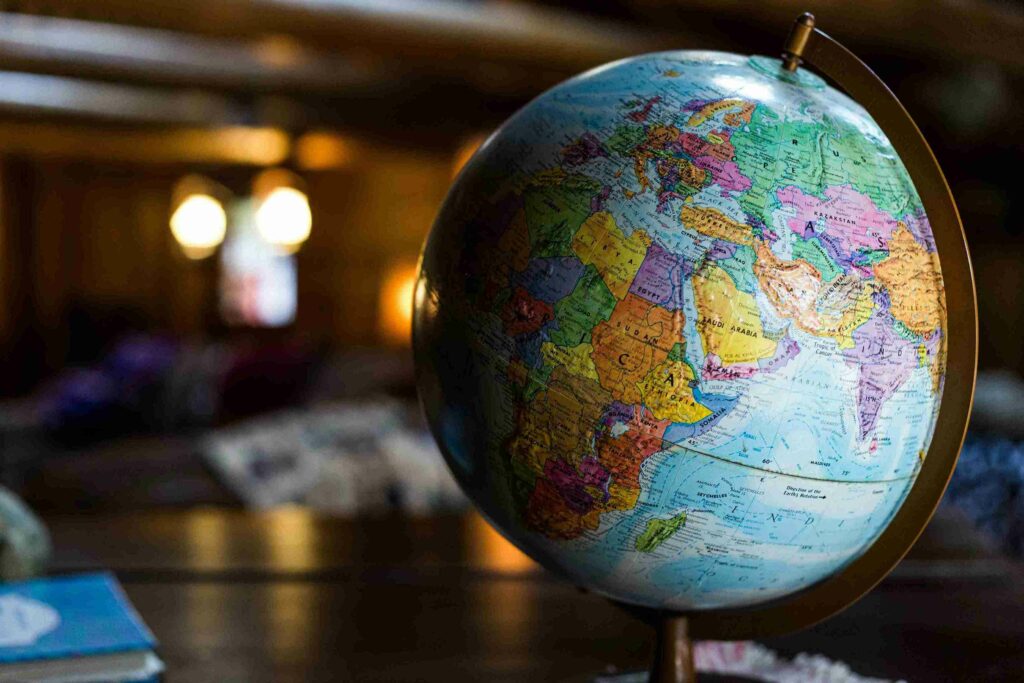 A close-up photo of a globe sitting on a table.