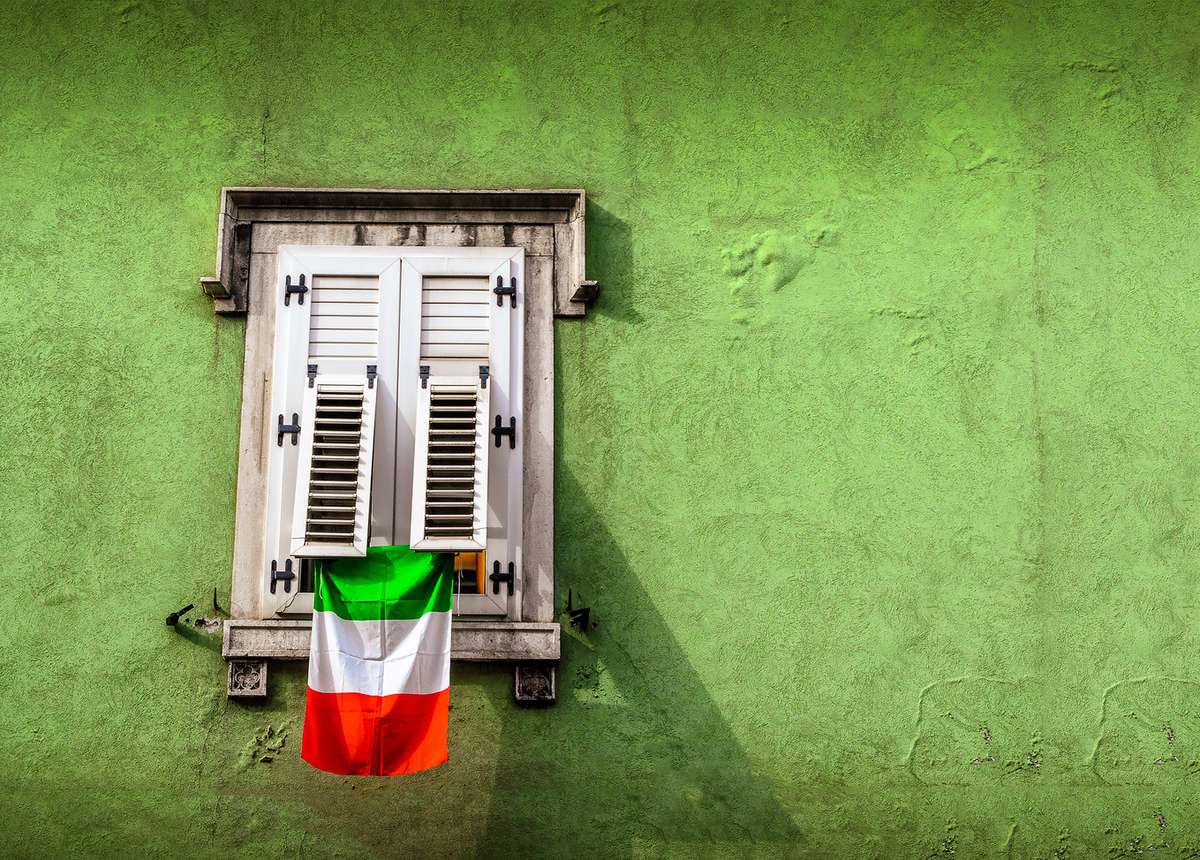 Image of a closed window with an italian flag