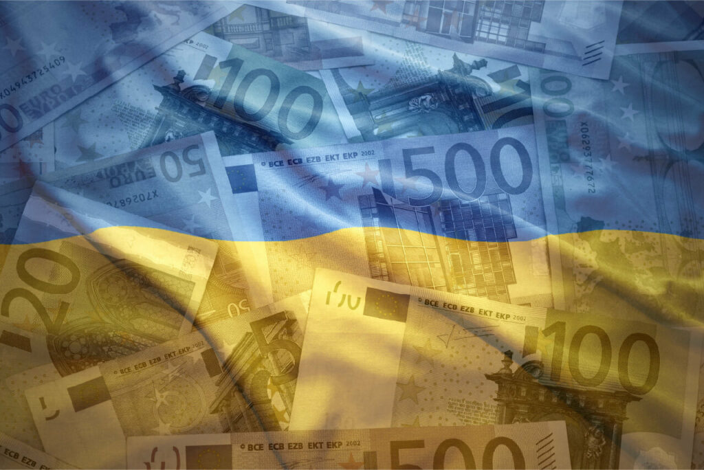 Colorful waving ukrainian flag on a euro money background, © luzitanija / Adobe Stock