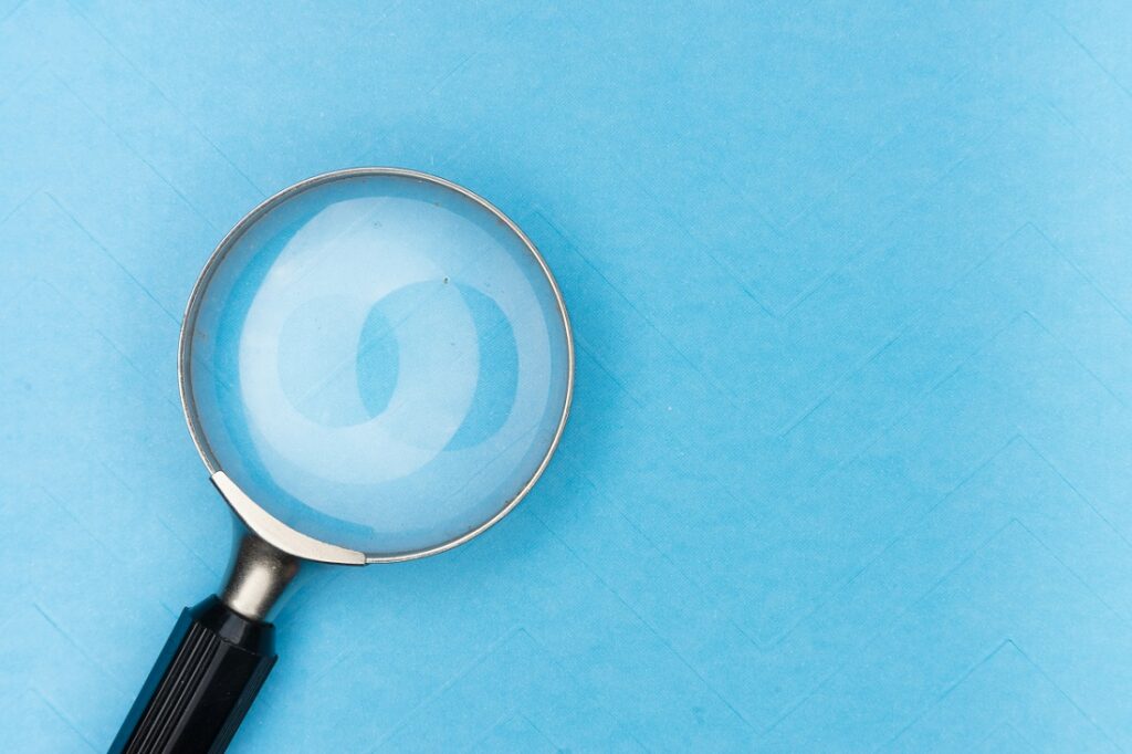 Image of a magnifying glass on a blue background