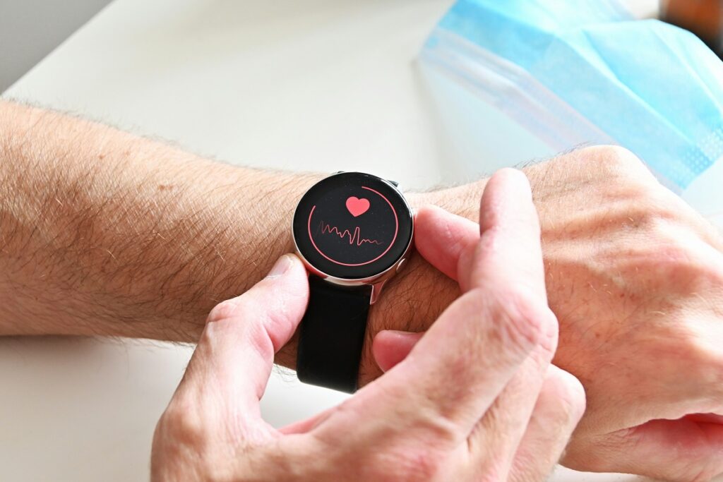 Photo of a smartwatch displaying heart rate tracking being worn on a wrist