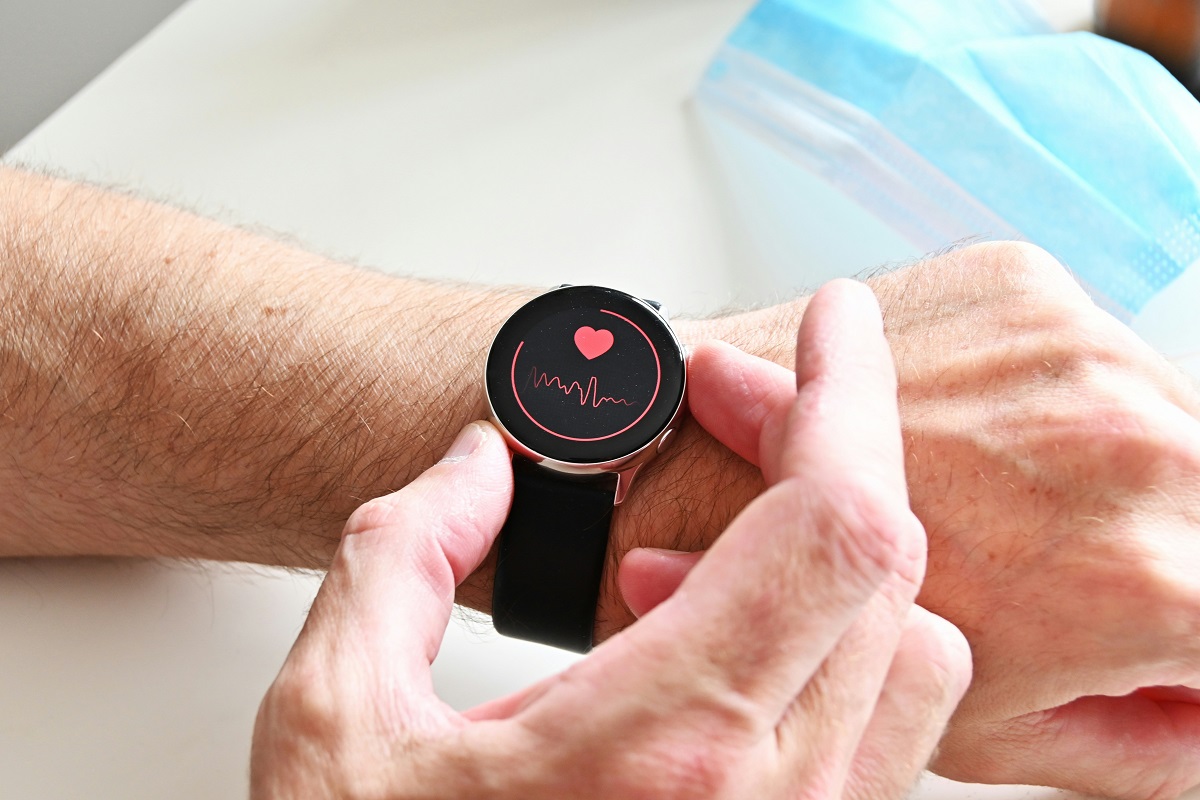 Photo of a smartwatch displaying heart rate tracking being worn on a wrist