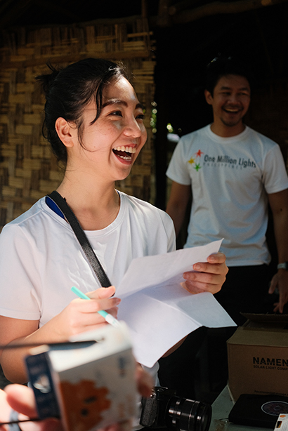 Photo of Jo Bautista handing out solar lamps with One Million Lights Philippines