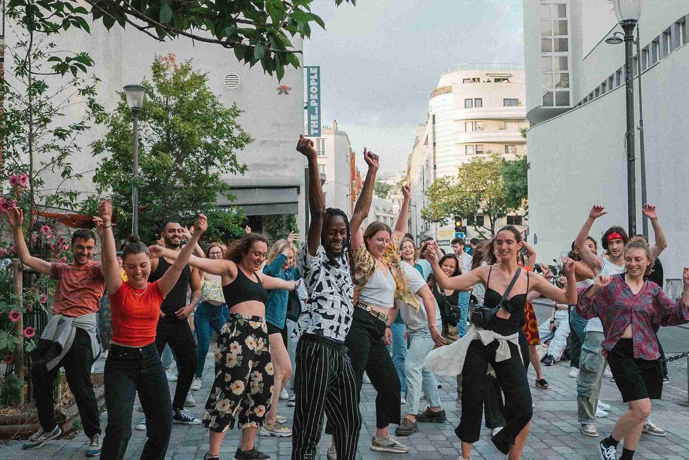 Group of people dancing in a city street