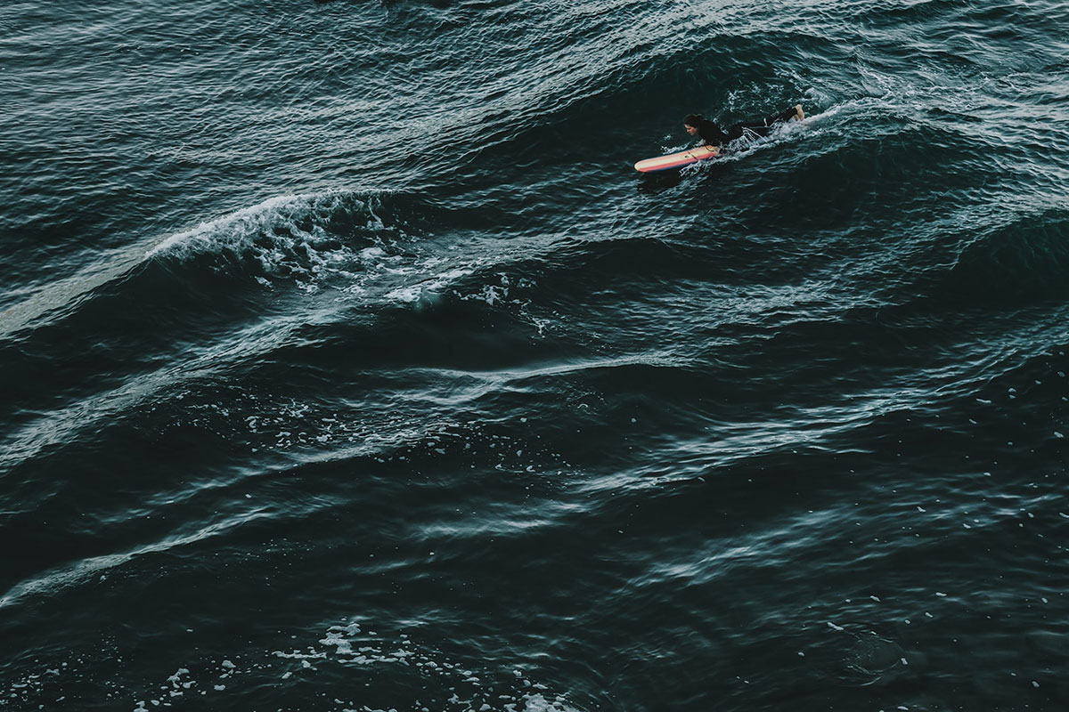 Photo of a surfer in the ocean.