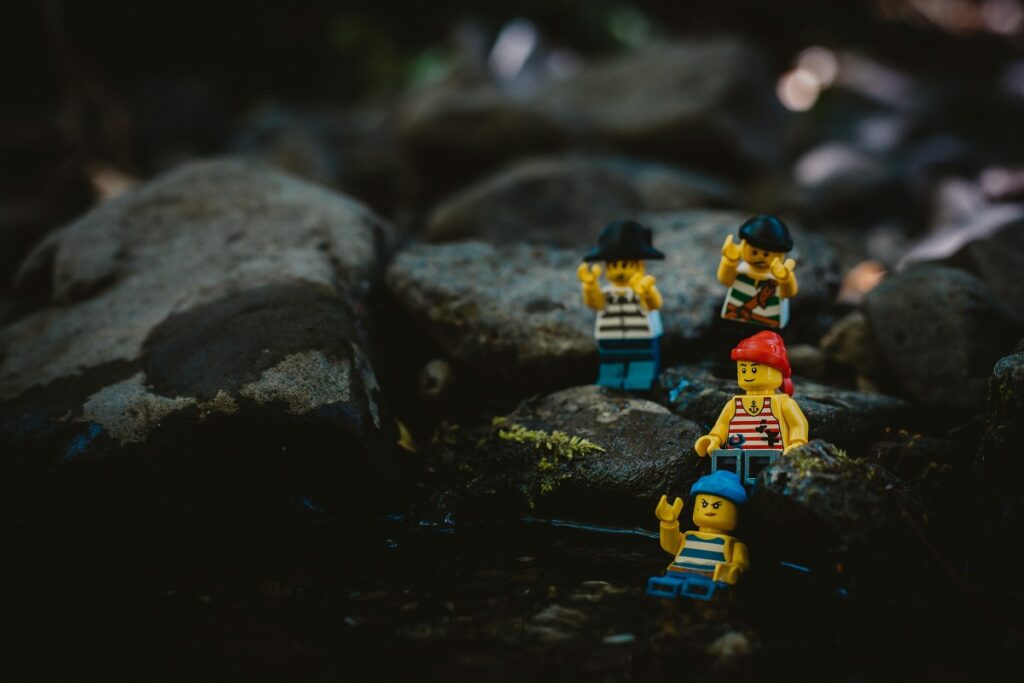 Lego characters dressed as pirates are navigating a rocky landscape
